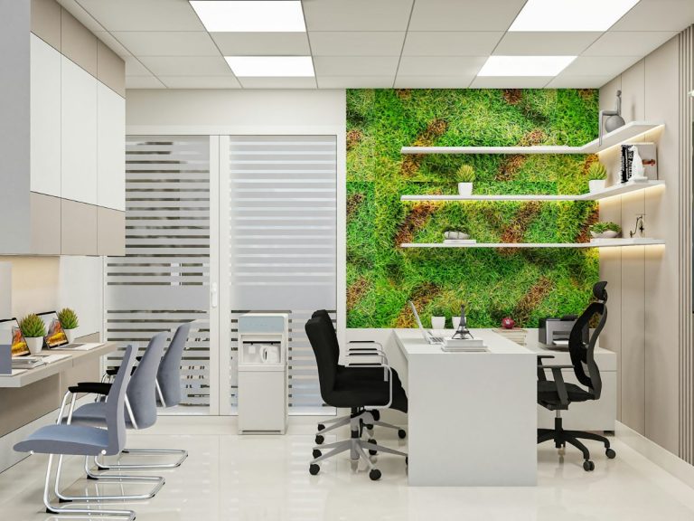 Modern shared office space with desks and a green plant wall