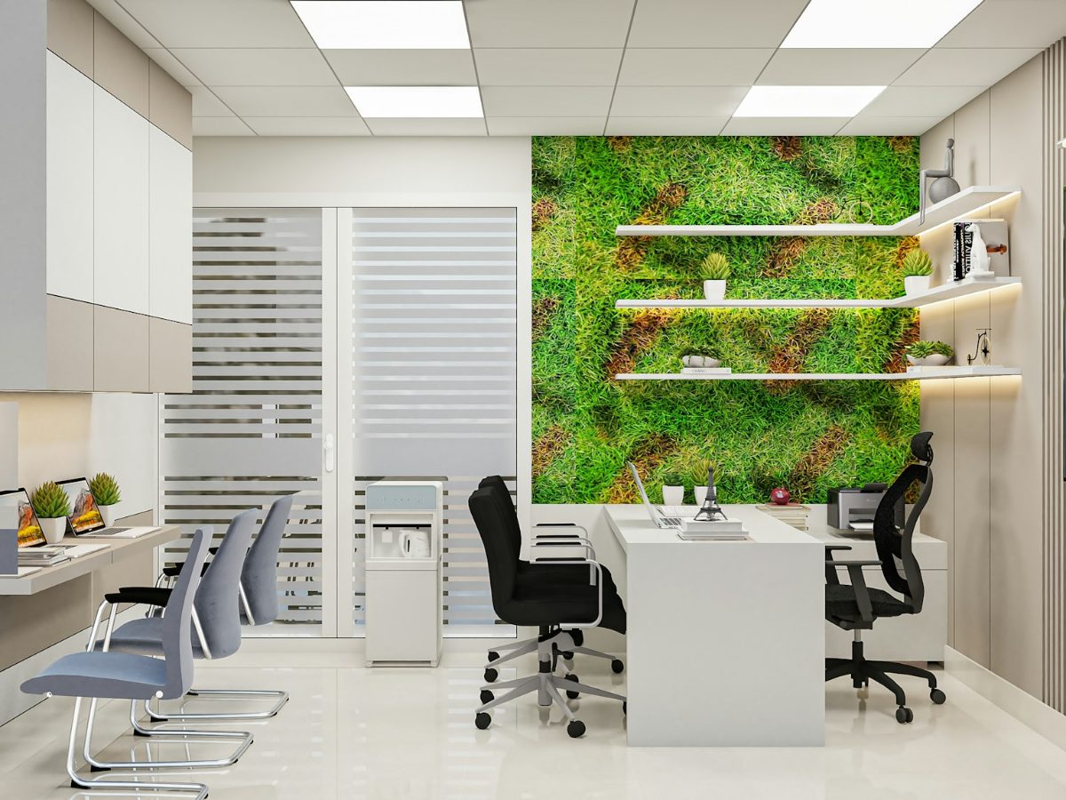 Modern shared office space with desks and a green plant wall